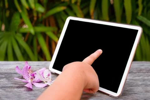 Child's hand touches the tablet Stock Photos