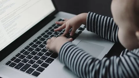 Child's hand touching laptop keyboard 動画素材 70817301