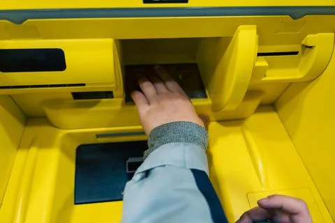 Child's Hand Using Push-Button Control Panel on ATM for Cash Withdrawal Foto stock