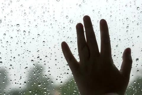 Child's hand on the windowpane Stock Photos