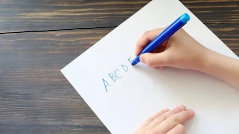 Child's hand writing letters Stock Footage 76154411