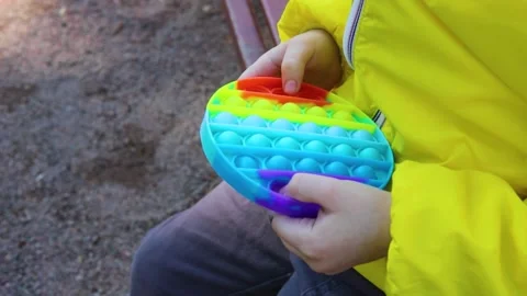 The child's hands are playing popit Stock Footage 165238207