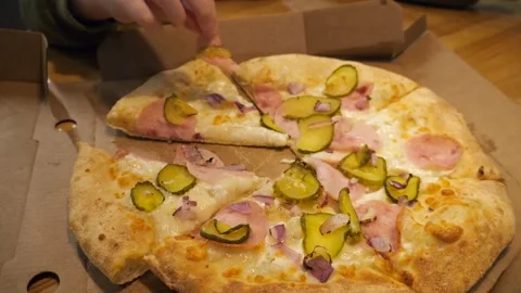 Childs hands carefully picking ham off a pizza loaded with melted cheese, onions Stock Footage 315029887