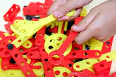 Child's hands with creative kit assembly tool Stock Photos