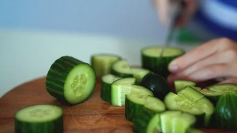Child's hands cutting cucumber. Stock Footage 70577394