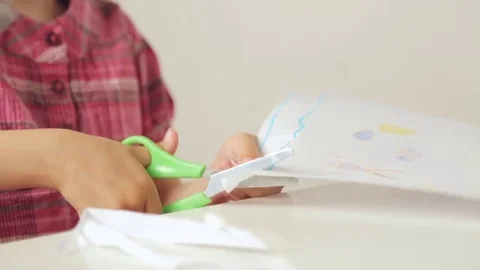 Child's hands cutting paper with scissors Video stock 81329702