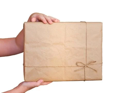 Child's hands hold a rectangular cardboard box isolated on a white background Stock Photos