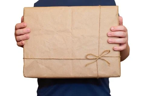 Child's hands hold a rectangular cardboard box isolated on a white background Stock Photos