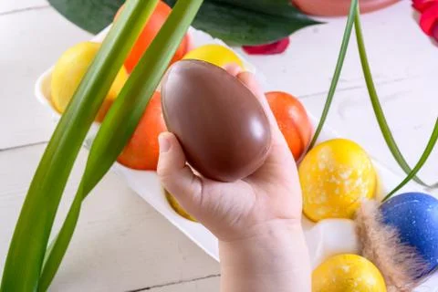 Child's hands holding chocolate Easter egg Stock Photos
