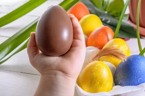 Child's hands holding chocolate Easter egg Stock Photos