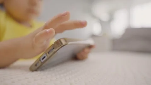 Childs hands holding mobile cell phone Stock Footage 245729119