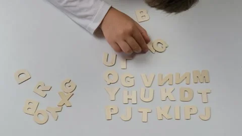 Child's hands lay out letters. Back to school soon Stock Footage 201628617