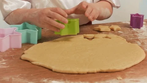 Child's hands making cookies from raw dough in the form of stars, close up. Stock Footage 74184036