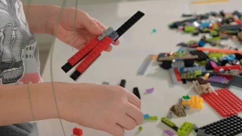Child's hands playing with a construction toy set, smart kid, plastic bricks Video stock 85205394