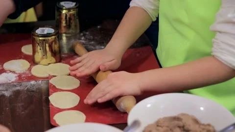 Child's hands roll out the dough on the table. children's hands energetically Stock Footage 232906118