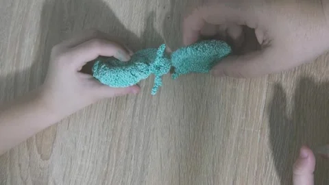 Child's hands shaping soft foam clay, creativity and sensory play in early .. Stock Footage 335085600