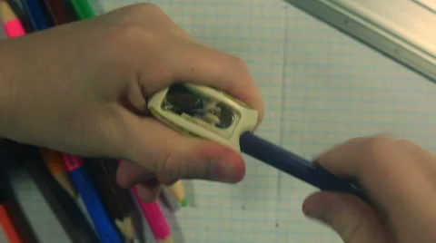 Child's hands sharpening a blue pencil Stock Footage 49628024