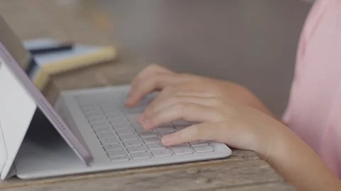 Childs hands typing on a portable computer keyboard, learning and education.. Stock Footage 338154428