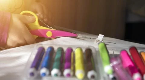Child's hands using scissors to cut paper. Stock Photos