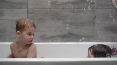 Childs playing in the bath with soap bubbles. Stock Footage 331254123