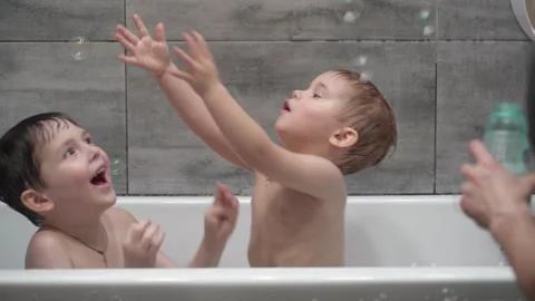 Childs playing in the bath with soap bubbles. Stock Footage 331254125