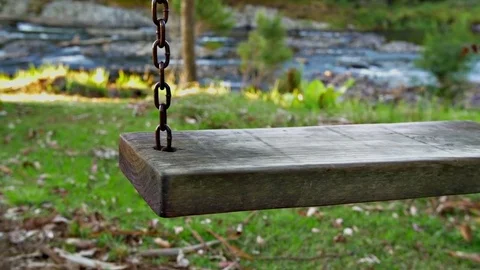 Childs swing moves softly Stock Footage 80460791