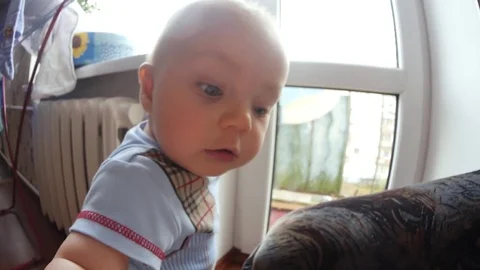 A child's view of the camera close up shot. Cute little baby is looking into the Stock Footage 84453901