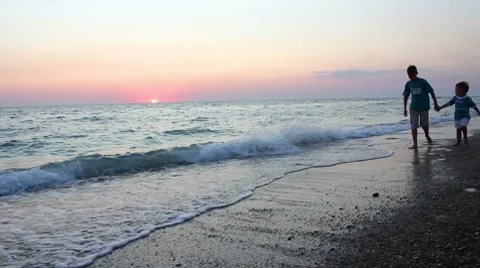 Childs walk on beach Stock Footage 8534053
