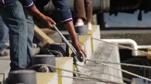 Chile, Chiloe, Securing Lines of Boat to Dock Stock Footage 22712853