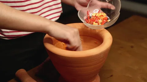 Chili and garlic pounded scooping medium shot Stock Footage 149113121