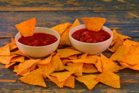 Chili corn-chips with salsa dip on wooden background Stock-Fotos