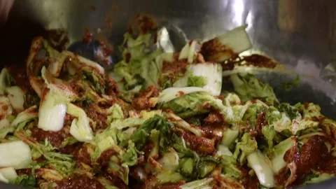 Chili paste component ingredient is garnished into napa cabbage in making Kim Stock Footage 172427983