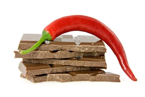 Chili pepper on stack of dark chocolate 스톡 사진