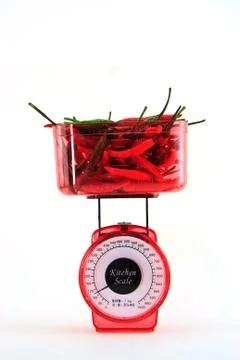 Chili on scale Stock Photos