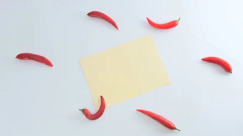 The chilli and piece of sheet is moving away from the white background Video stock 73009535