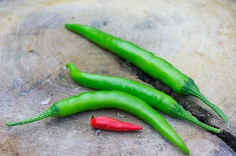 Chilli on chopping block Stock Photos