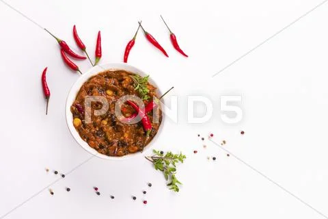 Chilli con carne and fresh whole chillies Stock Photos