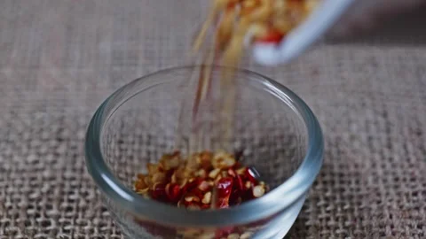 Chilli flakes dropping in bowl Stock Footage 272164563