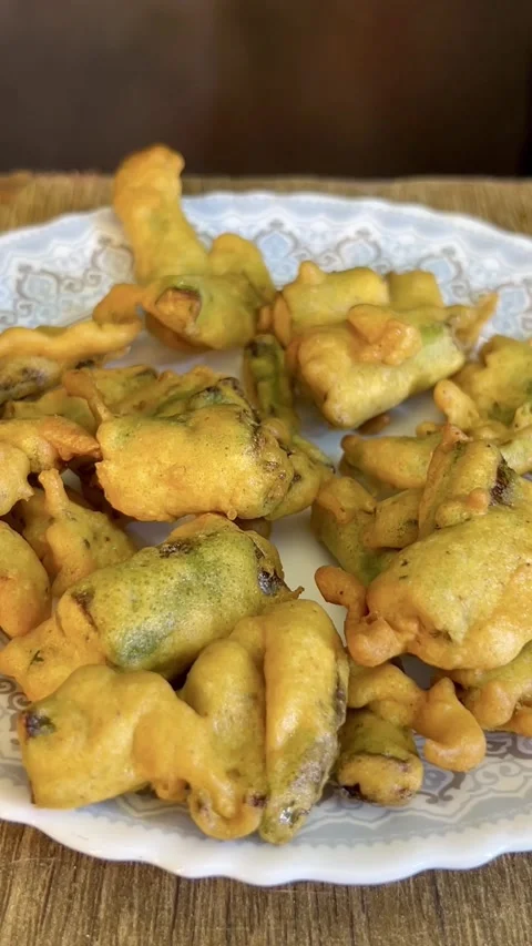 Chilli pakore or pakora made with gram flour served in a white ceramic plate. Stock Footage 287436435