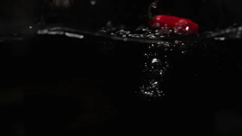 Chilli Pepper Falling into Water in Slowmotion Stock Footage 254592682