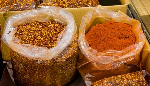 Chilli pepper pice in sacks outside on market Stock Photos