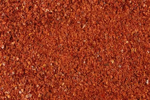 Chilli pepper seedless flakes background. Spices and food ingredients. Stock Photos