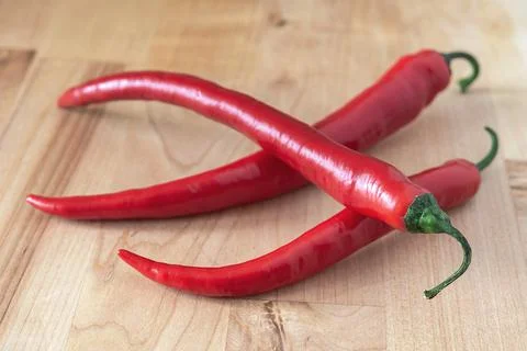 Chilli pepper on the wooden surface Stock Photos