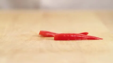 Chilli peppers being cut into fine strips Stock Footage 24651396