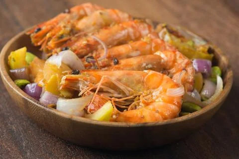 Chilli prawns in traditional setting Stock Photos