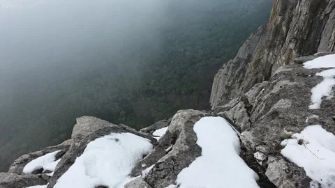 Chilly Mountain Edge. Cold Granite Ledge Rising Above Cloudcovered Tree Canopies 스톡 동영상 335267995