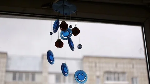 Chimes hanging in the window against the clouds Stock Footage 70865915