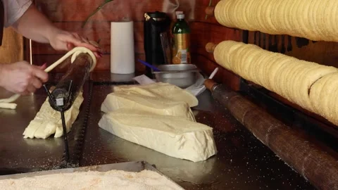 Chimney cake dough wrapping on roller with sugar coating Video stock 331811903