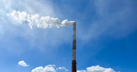 Chimney on a cloudy sky background with copyspace Stock Photos