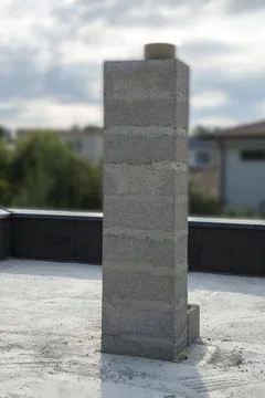 Chimney from concrete blocks under construction Stock Photos